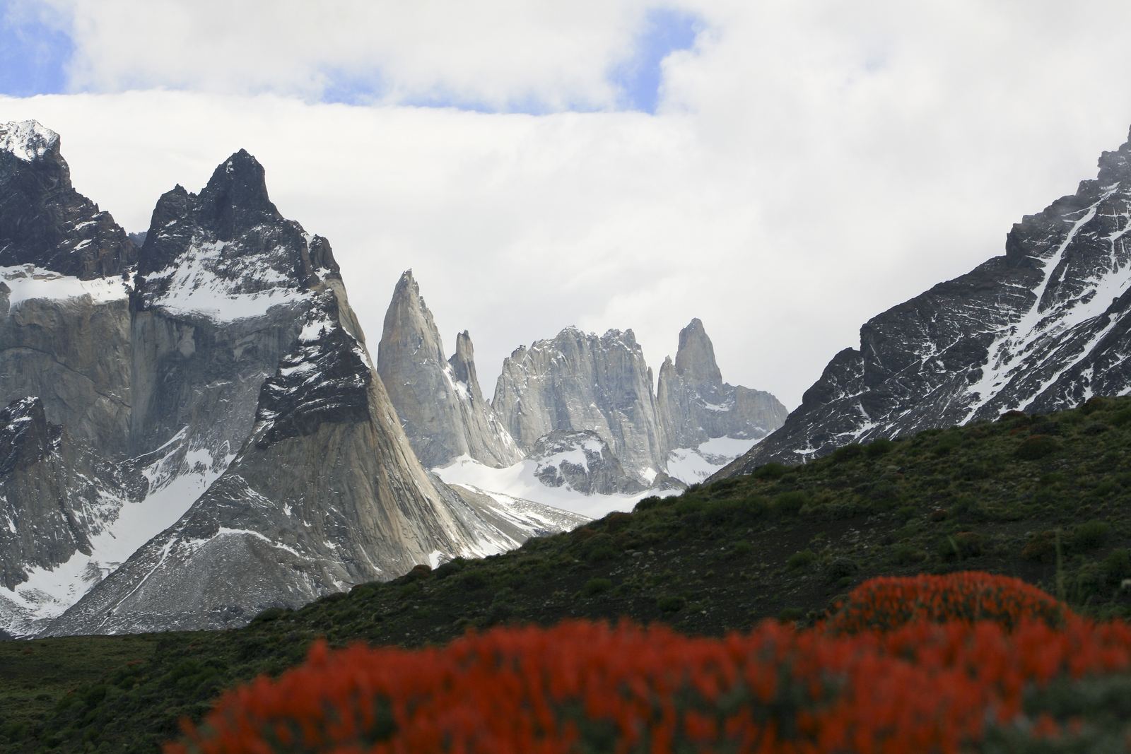 The dark-capped Cuernos del Paine peaks and granite towers above a blue lake